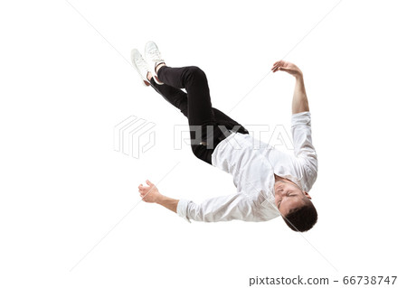 Mid-air beauty. Full length studio shot of attractive young man hovering in air and keeping eyes closed Mid-air beauty. Full length studio shot of attractive young man hovering in air and keeping eyes closed 66738747