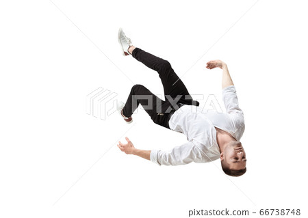 Mid-air beauty. Full length studio shot of attractive young man hovering in air and keeping eyes closed 66738748