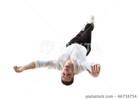 Mid-air beauty. Full length studio shot of attractive young man hovering in air and keeping eyes closed 66738754