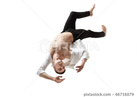 Mid-air beauty. Full length studio shot of attractive young man hovering in air and keeping eyes closed Mid-air beauty. Full length studio shot of attractive young man hovering in air and keeping eyes closed 66738879
