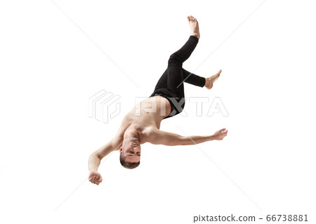 Mid-air beauty. Full length studio shot of attractive young man hovering in air and keeping eyes closed Mid-air beauty. Full length studio shot of attractive young man hovering in air and keeping eyes closed 66738881