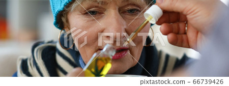 Elderly woman taking medicine Elderly woman taking medicine 66739426