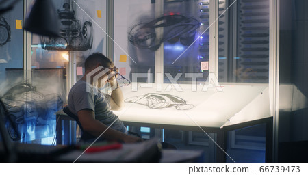 Car designer taking a short break during work Car designer taking a short break during work 66739473