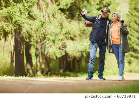 Active Senior Couple Taking Selfie Photo Outdoors 66739971