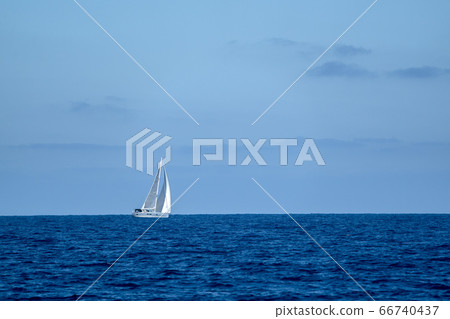 small sailboat on deep blue sea small sailboat on deep blue sea 66740437
