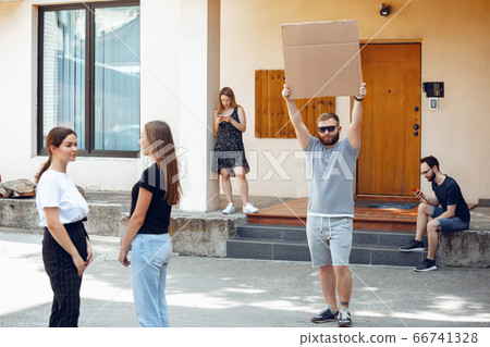 Dude with sign - man stands protesting things that annoy him 66741328