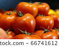 Wet fresh tomatoes on supermarket shelf. Red organic vegetables in grocery store. Healthy vegetarian food, nutrition, dieting. 66741612