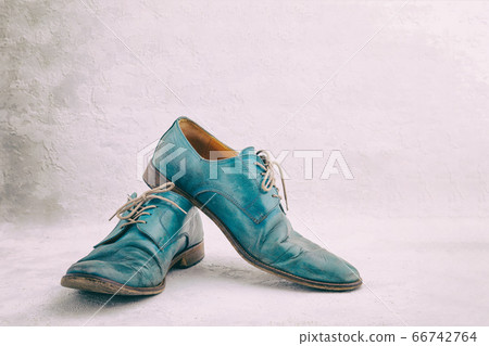 Pair of old leather blue discarded boots with laces Pair of old leather blue discarded boots with laces 66742764