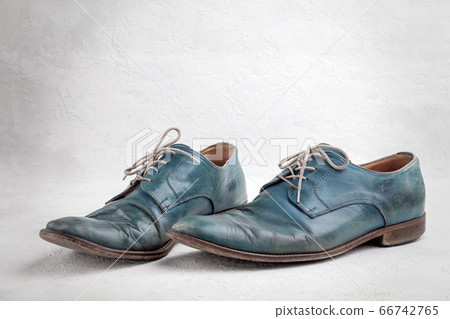 Pair of old leather blue discarded boots with laces Pair of old leather blue discarded boots with laces 66742765