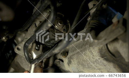 Installing crankcase protection by two auto mechanics. 66743656