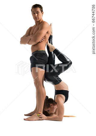 Young couple in sportswear exercising view Young couple in sportswear exercising view 66744786