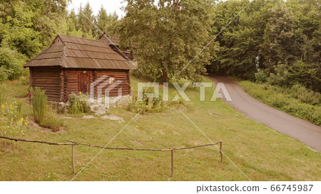 Log small building in the forest. 66745987