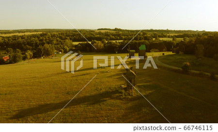 Wooden windmills in big meadow. Wooden windmills in big meadow. 66746115