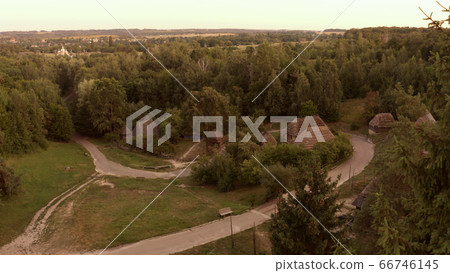 Road crosses the village in the forest. Road crosses the village in the forest. 66746145