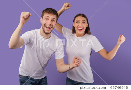 Portrait of cheerful people smiling and clenching fists 66746946