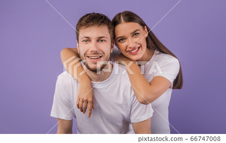 Portrait of beautiful young couple smiling at studio 66747008