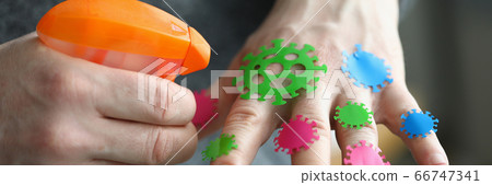 Male hand vith coronavirus covid19 bacteria closeup 66747341