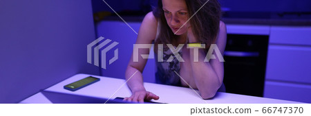 Adult sad caucasian woman with laptop on kithen portrait Adult sad caucasian woman with laptop on kithen portrait 66747370