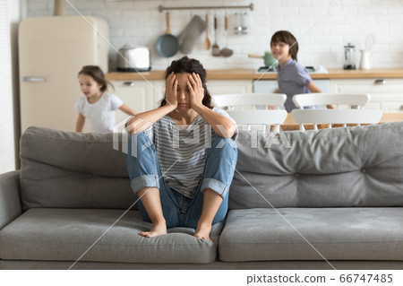 Hyperactive kids tired and running near upset mother. Hyperactive kids tired and running near upset mother. 66747485