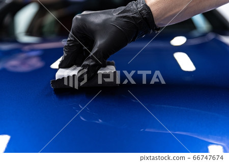 Man worker of car detailing studio applying Man worker of car detailing studio applying 66747674