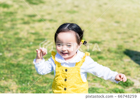 Cute girl playing in park with children 66748259