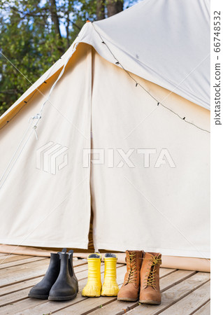 Close-up of glamping bell tent with shoes. Family camping concept 66748532
