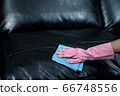 Woman wipe sofa with germicidal spray and wipe with towel. 66748556