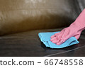 Woman wipe sofa with germicidal spray and wipe with towel. 66748558