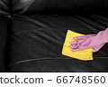 Woman wipe sofa with germicidal spray and wipe with towel. 66748560