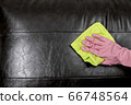 Woman wipe sofa with germicidal spray and wipe with towel. 66748564