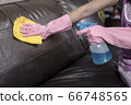 Woman wipe sofa with germicidal spray and wipe with towel. 66748565