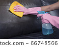 Woman wipe sofa with germicidal spray and wipe with towel. 66748566