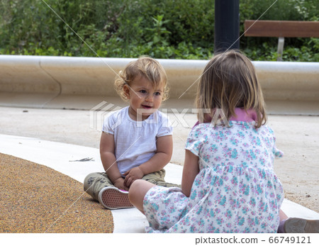 baby girl sitting with an older girl baby girl sitting with an older girl 66749121