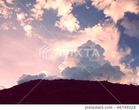 Dramatic sunset sky with clouds under mountains 66749328