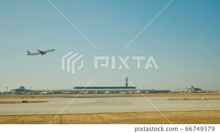Passenger plane fly up over take-off runway from airport. 66749379
