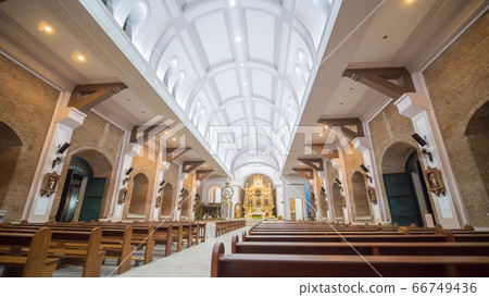 Interior inside the Catholic temple in the Philippines. Parishioners and tourists near the Christmas nativity scene. Prayers. Excursions. Interior inside the Catholic temple in the Philippines. Parishioners and tourists near the Christmas nativity scene. Prayers. Excursions. 66749436