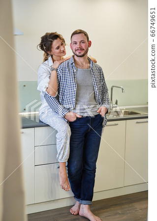 A loving wife looks at her husband at home. A loving wife looks at her husband at home. 66749651