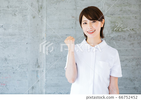 A smiling nurse in a white coat A smiling nurse in a white coat 66752452