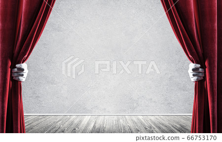 Concrete wall behind drapery curtain and hand opening it Concrete wall behind drapery curtain and hand opening it 66753170