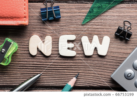 New word on wooden table and office stationary around New word on wooden table and office stationary around 66753199