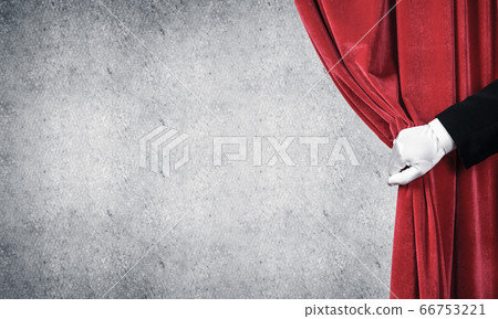 Concrete wall behind drapery curtain and hand opening it 66753221