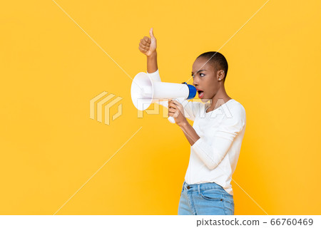 African American woman shouting and giving thumbs up 66760469
