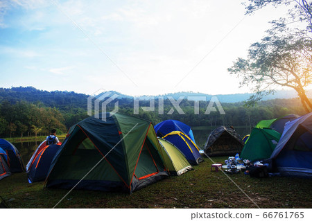 Tent camping at river in the morning sunlight. Tent camping at river in the morning sunlight. 66761765