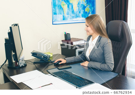 Woman office manager at the desk in the office. 66762934