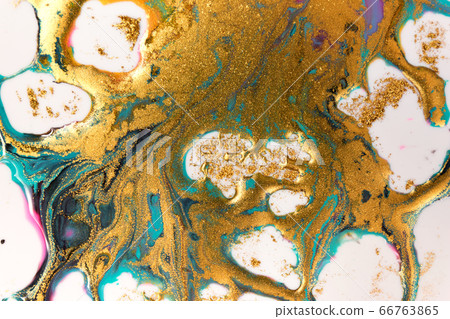 Golden inks splattered on white paper background. Golden glitter 66763865