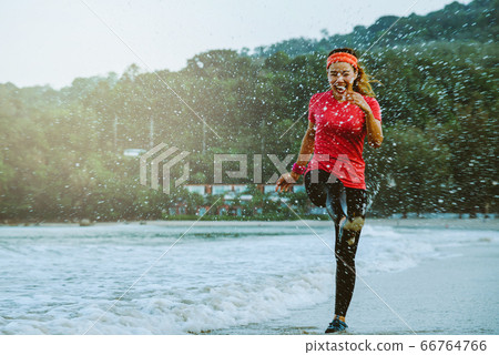 asian woman jogging workout on the beach in the morning. Relax with the beach asian woman jogging workout on the beach in the morning. Relax with the beach 66764766