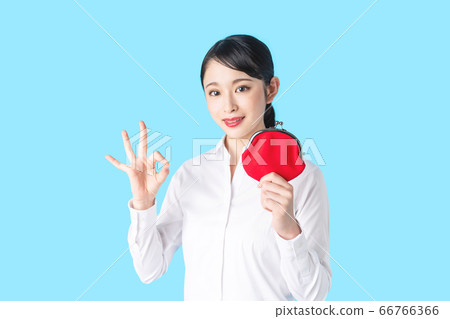 A woman showing an OK sign with a wallet A woman showing an OK sign with a wallet 66766366