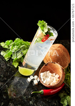 Cocktail with rum, coconut, cilantro, lime and 66767121