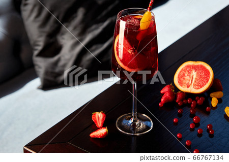 Glass of aperol spritz cocktail on wooden table in 66767134