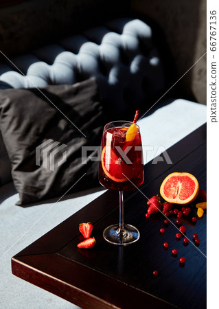 Glass of aperol spritz cocktail on wooden table in 66767136